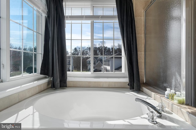 full bathroom featuring a wealth of natural light and a bathing tub