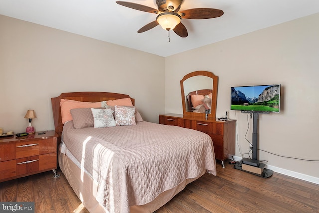 bedroom featuring dark wood-style flooring, ceiling fan, and baseboards