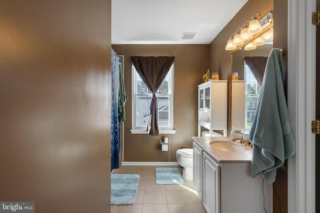 bathroom featuring plenty of natural light, tile patterned flooring, visible vents, and vanity