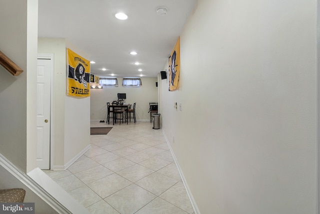 hall with light tile patterned floors, baseboards, and recessed lighting