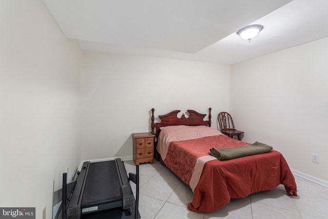 bedroom featuring light tile patterned floors and baseboards