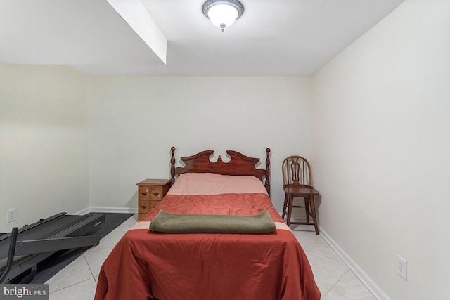 bedroom with baseboards and light tile patterned flooring