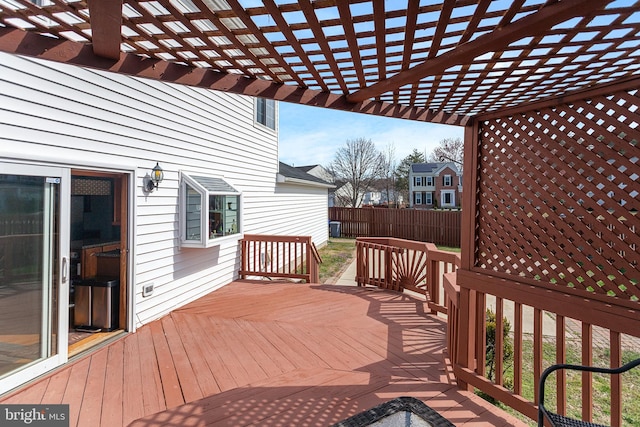 deck featuring fence and a pergola