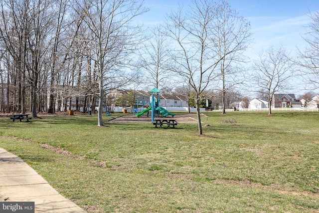 view of community with playground community and a yard