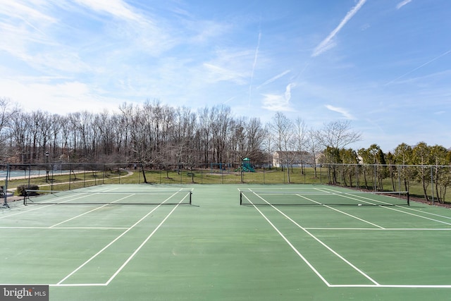 view of tennis court featuring fence