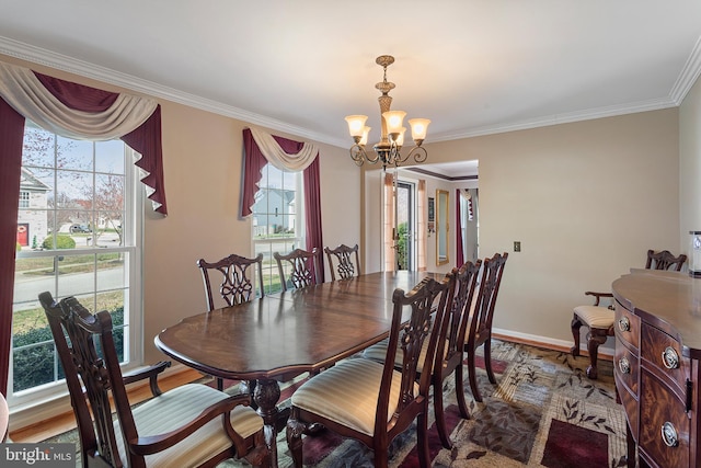 dining space with crown molding, baseboards, wood finished floors, and an inviting chandelier