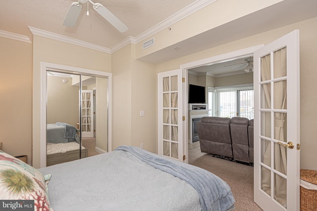 bedroom featuring crown molding, ceiling fan, a closet, and carpet floors