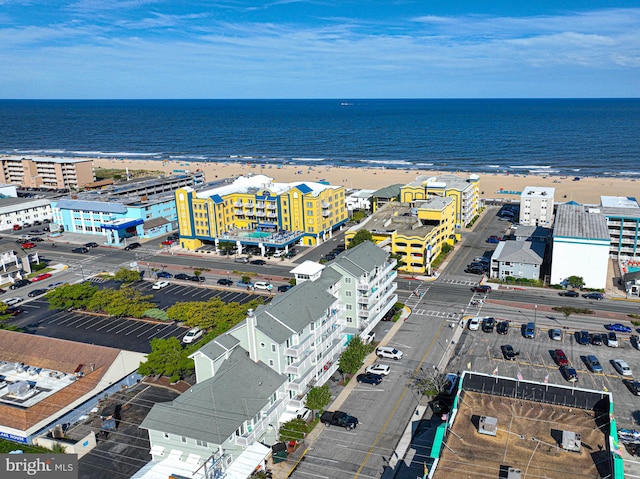 birds eye view of property with a beach view and a water view