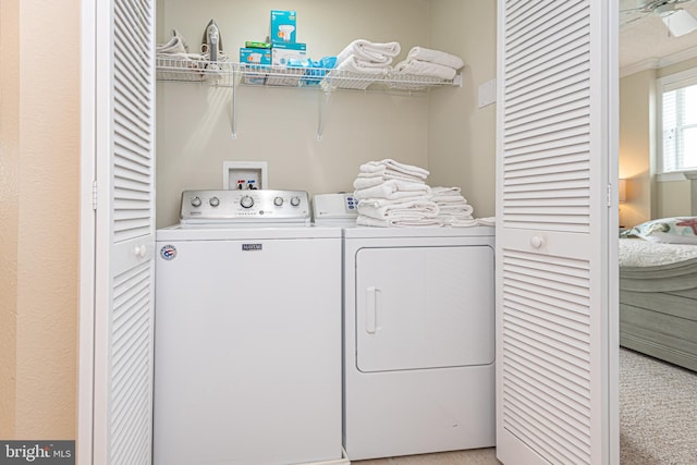 laundry room with light carpet and washing machine and dryer