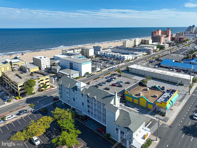 birds eye view of property with a beach view and a water view