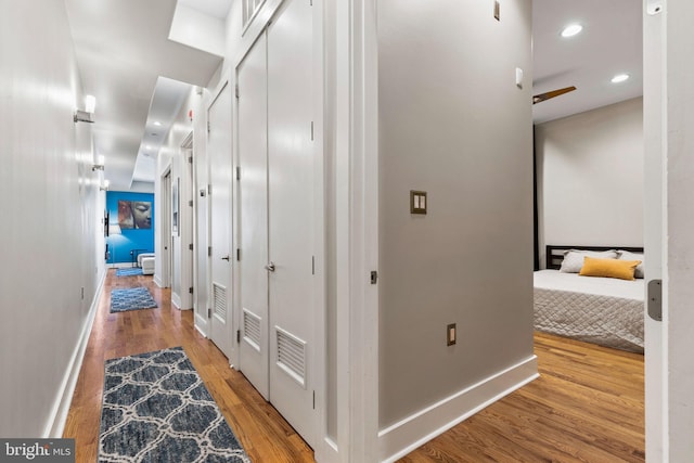 hallway with hardwood / wood-style floors