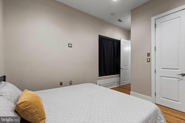 bedroom with hardwood / wood-style flooring