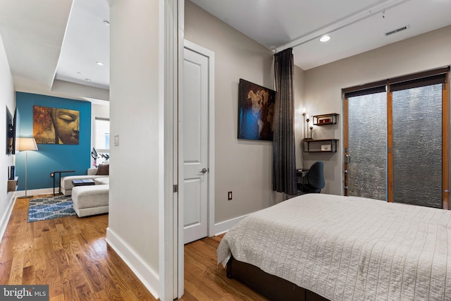 bedroom with hardwood / wood-style floors