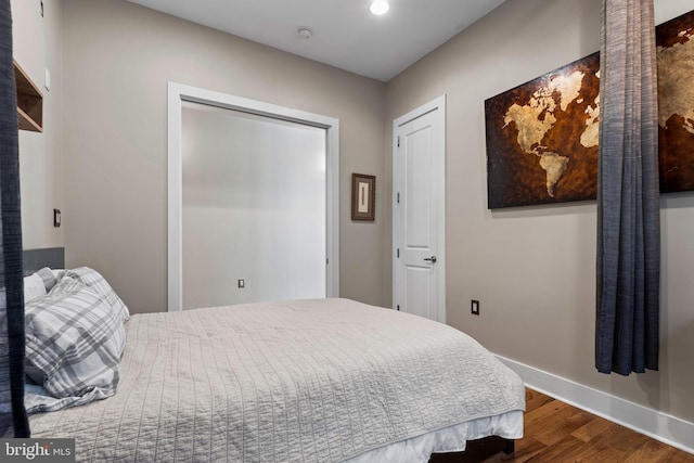 bedroom featuring a closet and dark hardwood / wood-style flooring