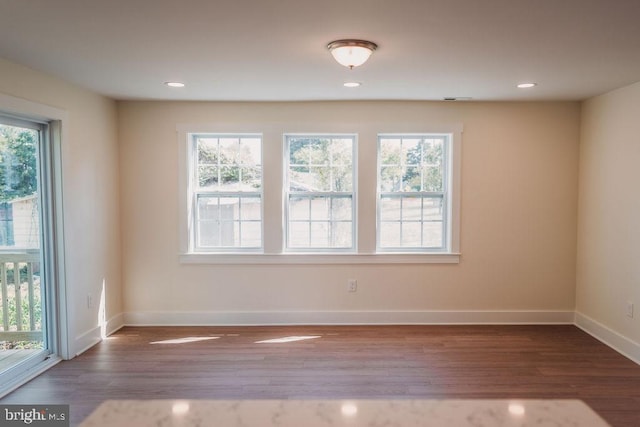 empty room featuring dark hardwood / wood-style flooring