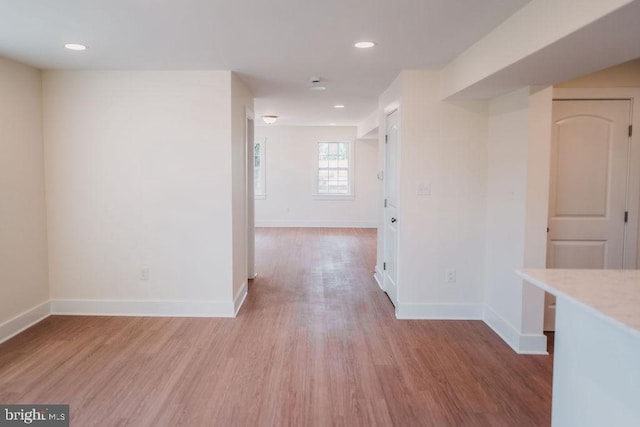 hallway with light hardwood / wood-style flooring