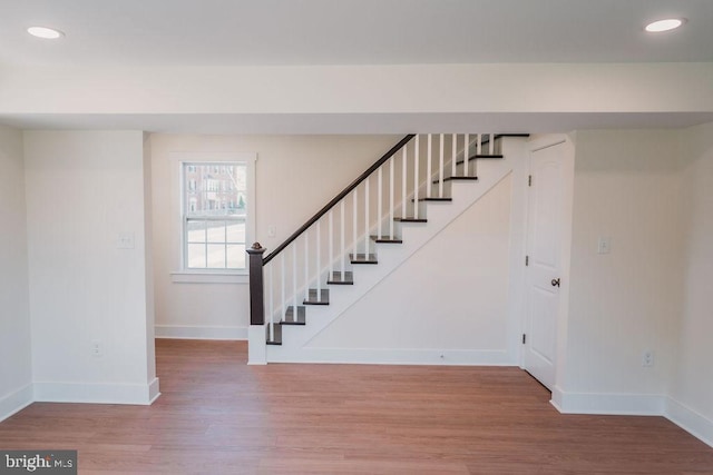 stairs featuring hardwood / wood-style flooring