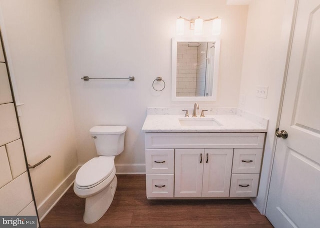 bathroom featuring wood-type flooring, vanity, and toilet