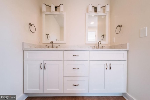 bathroom featuring vanity and hardwood / wood-style floors