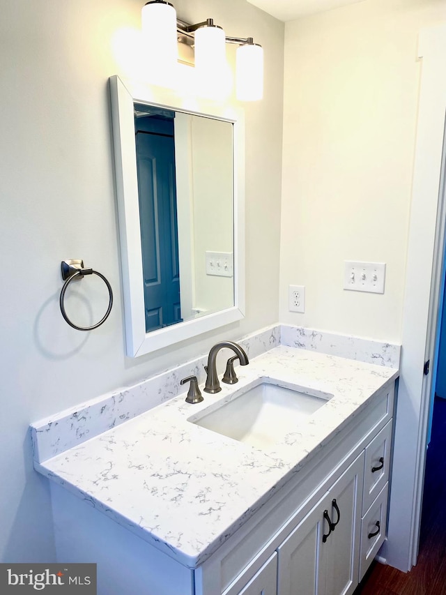 bathroom featuring hardwood / wood-style flooring and vanity