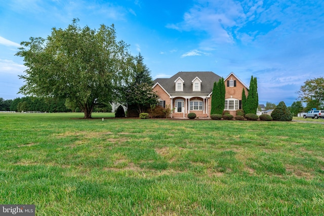 new england style home with a front lawn