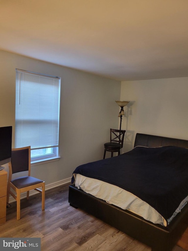 bedroom with hardwood / wood-style flooring