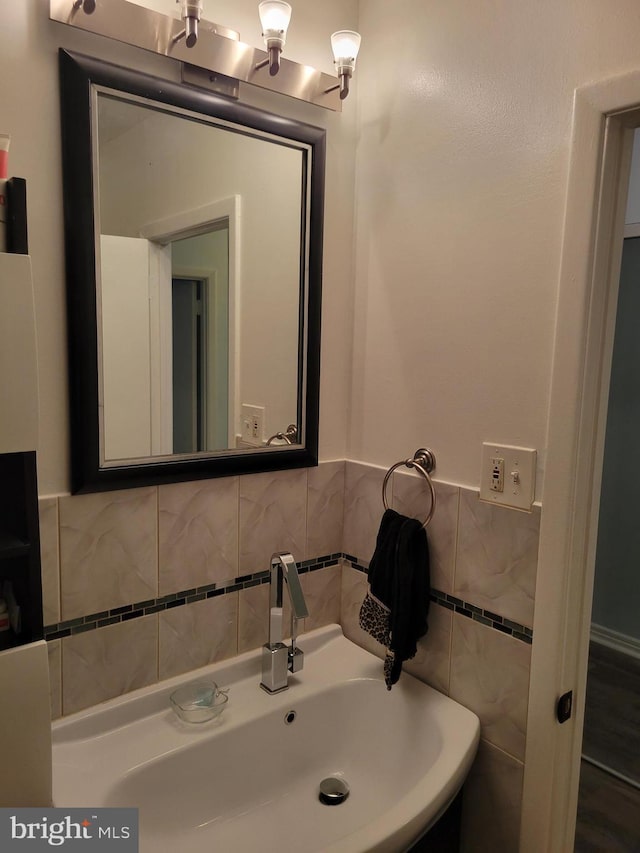 bathroom with tile walls and sink