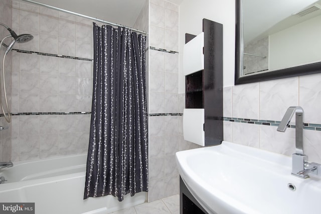 bathroom with tile walls, shower / tub combo, and vanity