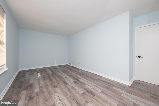 unfurnished room with light wood-type flooring