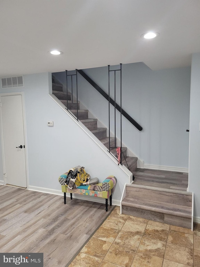 stairs featuring hardwood / wood-style flooring