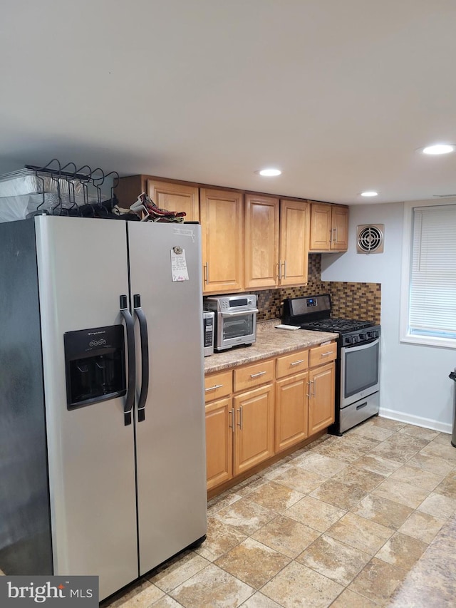 kitchen with decorative backsplash and appliances with stainless steel finishes