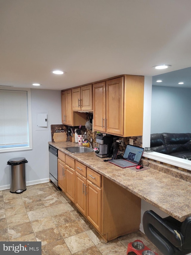 kitchen with backsplash, sink, and stainless steel dishwasher