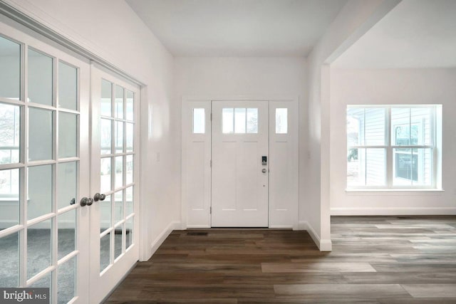 entrance foyer with a wealth of natural light, french doors, baseboards, and dark wood-style flooring