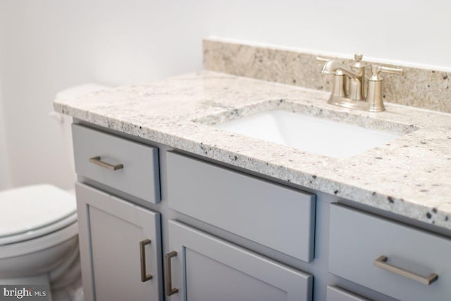 bathroom featuring toilet and vanity