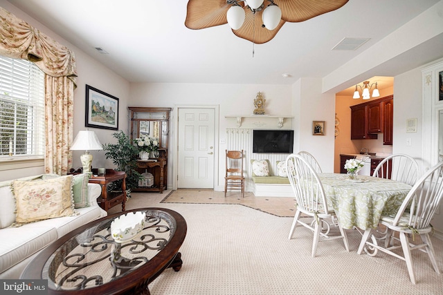 dining area featuring ceiling fan with notable chandelier and light tile patterned floors