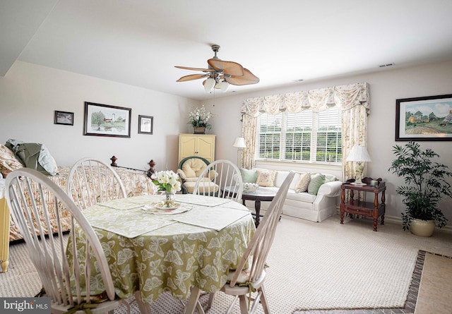 dining room with ceiling fan and carpet floors