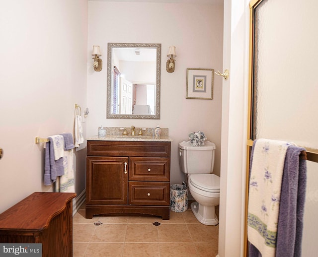 bathroom featuring tile patterned flooring, vanity, toilet, and a shower with door