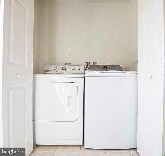 4116 Harford Creamery Rd, White Hall, MD 21161 - laundry room featuring light tile patterned floors, laundry area, and washing machine and clothes dryer