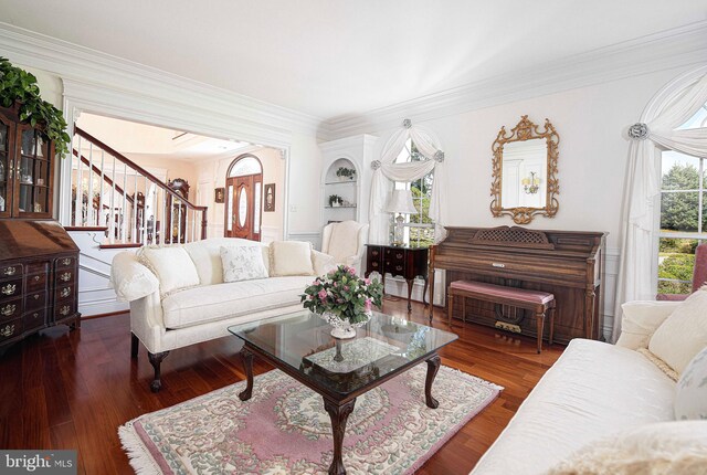 living room with ornamental molding and dark wood-type flooring