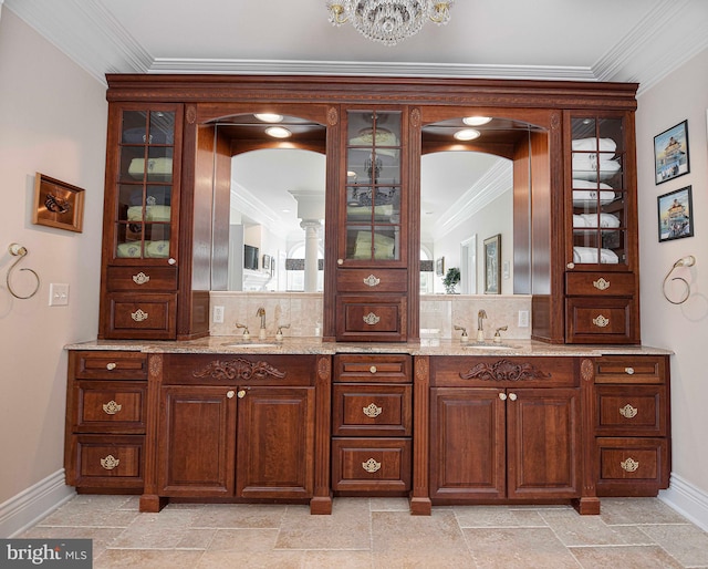 interior space with ornamental molding, backsplash, light stone counters, and sink