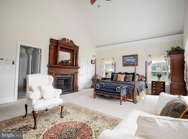 carpeted living room with a high ceiling and a high end fireplace