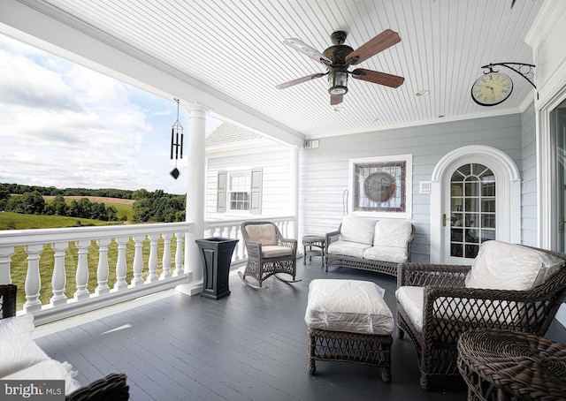 deck featuring ceiling fan and outdoor lounge area