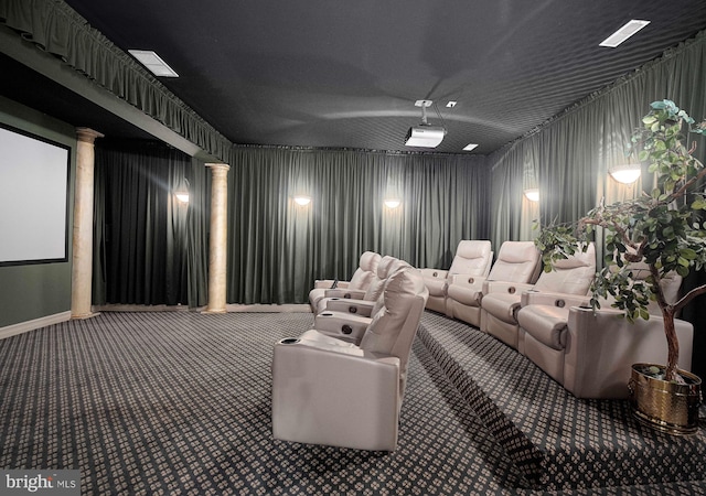 carpeted cinema room featuring decorative columns