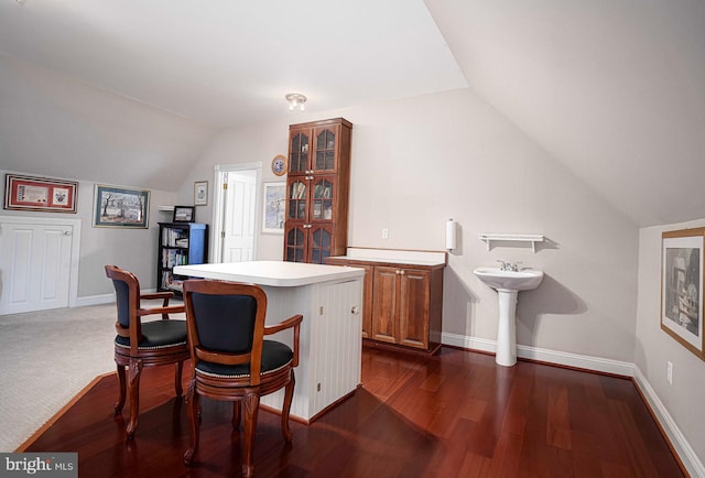 home office featuring lofted ceiling and dark hardwood / wood-style floors