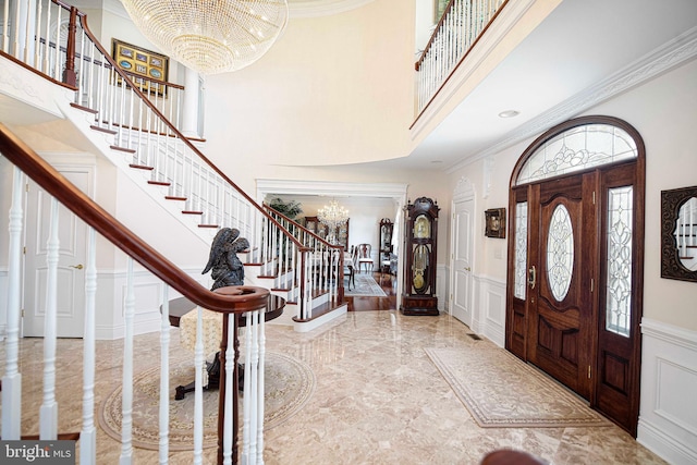 4116 Harford Creamery Rd, White Hall, MD 21161 - foyer featuring wainscoting, a decorative wall, a high ceiling, stairway, and a chandelier