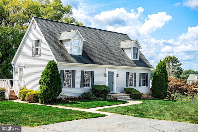 cape cod house with a front lawn