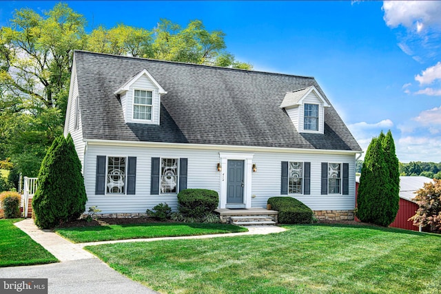 new england style home featuring a front yard