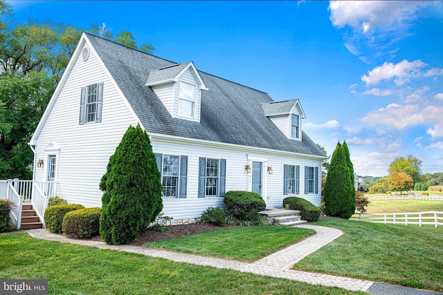 cape cod house with a front lawn