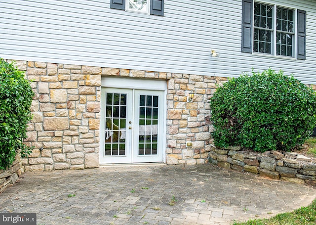 property entrance featuring french doors and a patio area