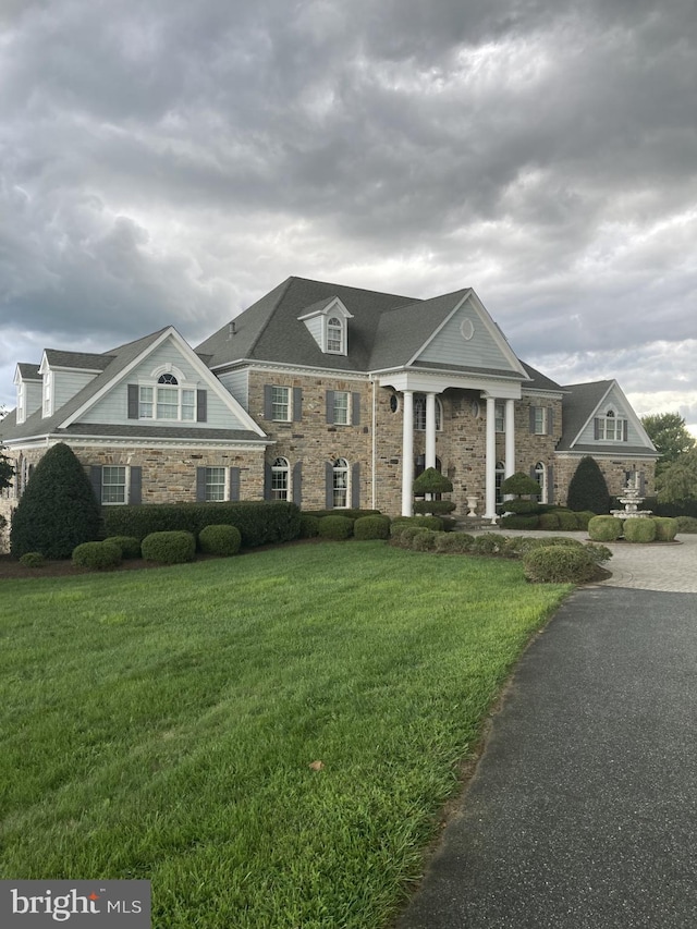 greek revival inspired property with a front yard